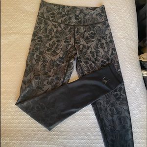 Dark butterfly pattern leggings fades into black